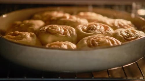 Cinnamon Rolls Rising and Baking in Oven