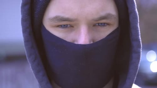 Young Handsome Man With His Hoodie Wearing A Black Protective Facemask During The Coronavirus Outbre