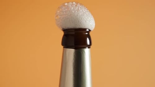 Opening a Beer Bottle with Foam Erupting