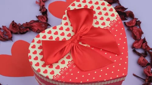 Heart-Shaped Gift Box with Red Ribbon and Hearts