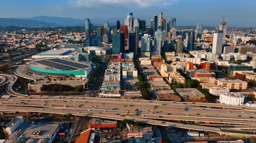 Wide-lane highway with multiple moving cars in front of the downtown of Los Angeles, California, USA