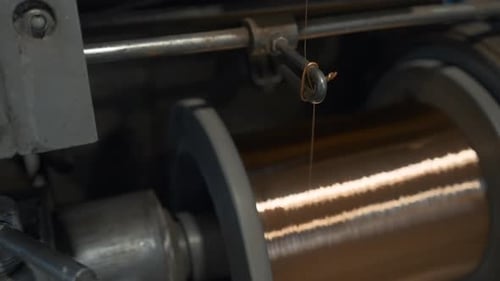 Close-up of coil winding copper wire. Creative. Shiny copper wire is wound on coil at metallurgical