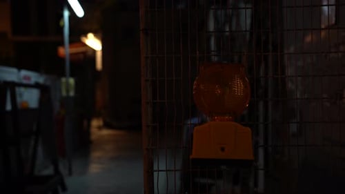 Placa de trânsito laranja piscando alertando pedestres e motoristas sobre reparos em estradas na rodovia da cidade. desfoque