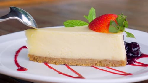 Cheesecake Slice Being Eaten with Spoon