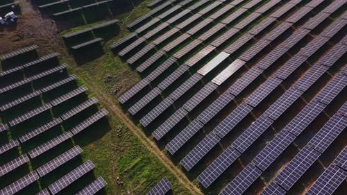 Solar panel array installed in a large outdoor field for energy generation
