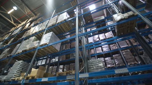 Camera Moving Between Palettes with Ordered Materials at Warehouse. Large Warehouse Logistics