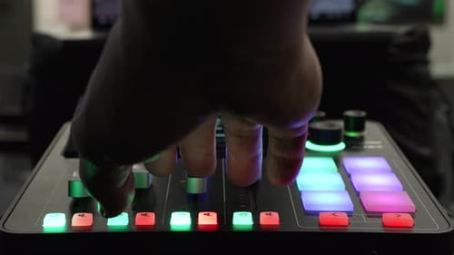 Hand Adjusting Levels on Mixing Board