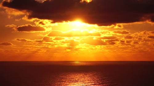 Timelapse Dramatic Sunset with Fluffy Clouds Moving in Golden Burning Sky Over Sea Abstract Aerial