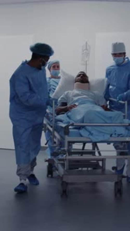 Doctors and Paramedics Push Stretcher in Clinic