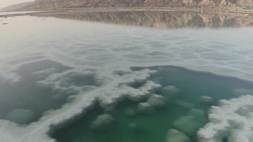 Dead sea salt Formation with mountain reflection, Aerial view
