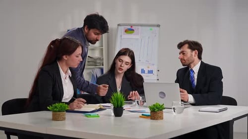 Business Meeting with Four People in Office Setting