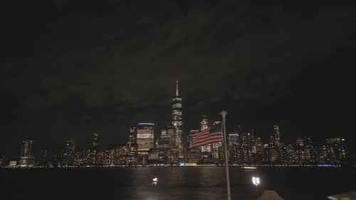 New York City Skyline at Night with Flag
