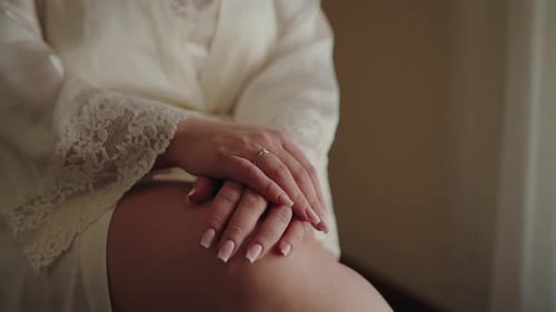 Woman Wearing Ring and Silky Robe, Close Up