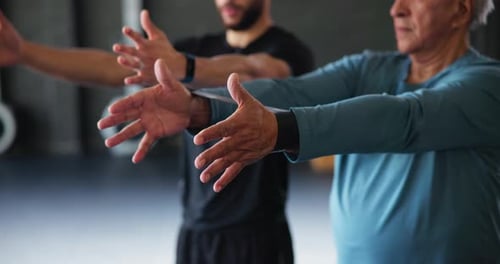 Men Stretching With Resistance Band in Fitness Studio