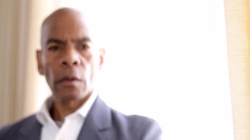 Man Holds Up Hand to Stop Something