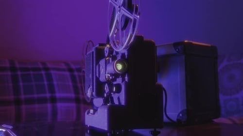 Vintage Movie Projector Glowing in Blue and Purple