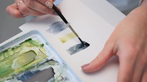 Close Up of Artist Painting Watercolor Shapes