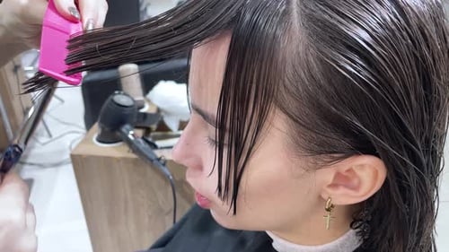 Woman Getting Haircut at Beauty Salon
