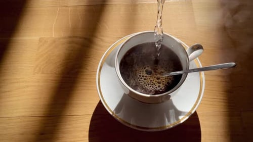 Pouring Hot Water Into White Cup Chocolate and Coffee Fresh Morning Pour Over Coffee Close Up Slow