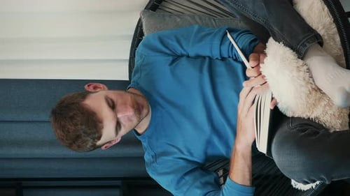Man Relaxing and Reading Book Indoors