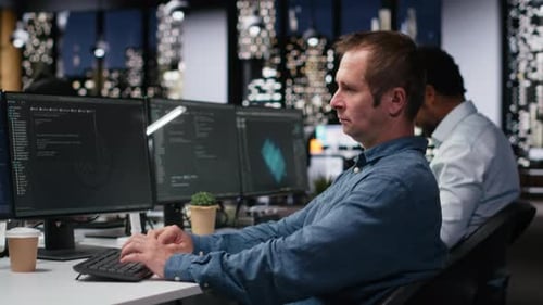 Tech Agency Computer Scientist Using AI to Optimize Software in Office