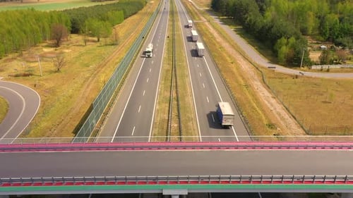 Traffic of cars and trucks on the Freeway in Summer day - top view shot. Top View shot of multi-lan