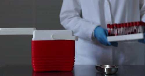 Medical Professional Handling Blood Samples in a Laboratory