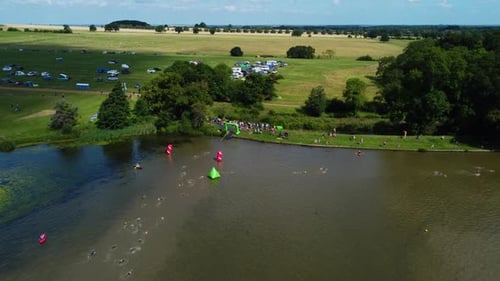 Triathlon competition zone, swimming and running on land. Aerial view.