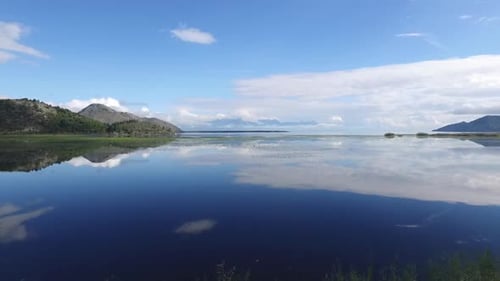 A Peaceful and Serene Lakeside View Showcasing Stunning Mountains and Their Beautiful Reflections