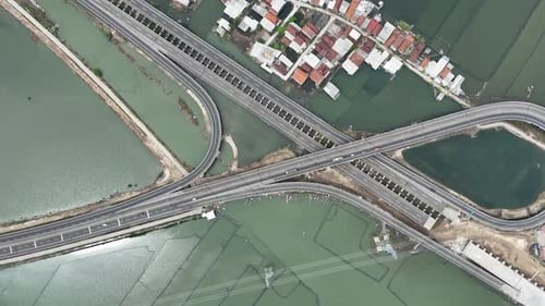 Aerial view of water ponds with highway near residential area