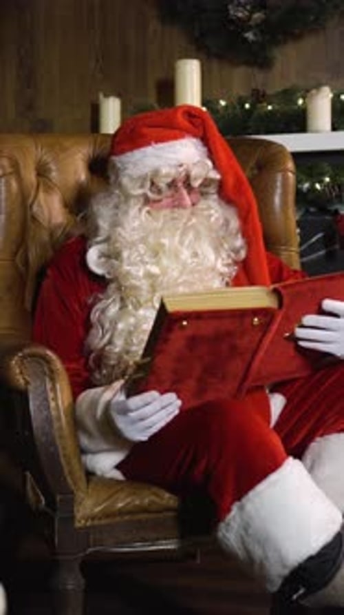 Santa Claus Reading a Book in Armchair