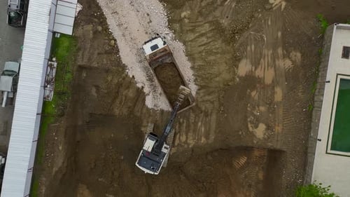 Aerial View Excavator Loading Truck at Construction Site
