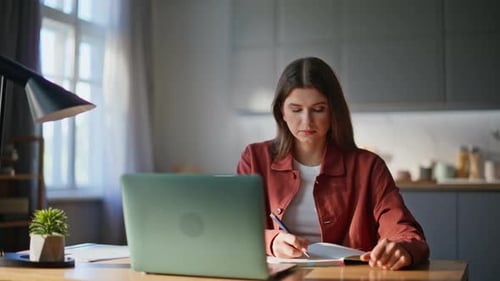 Woman Working on Laptop at Home Office Desk