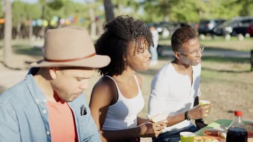 Multiethnic Group of Friends Eating in a Park