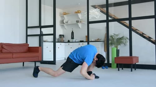 Man Stretching and Exercising in Modern Living Room