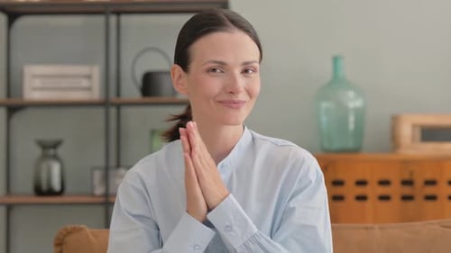 Woman Smiling and Clapping Hands Indoors