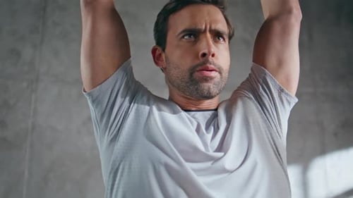 Powerful Man Lifting Weight Plate in Sport Club Closeup Bodybuilder Training