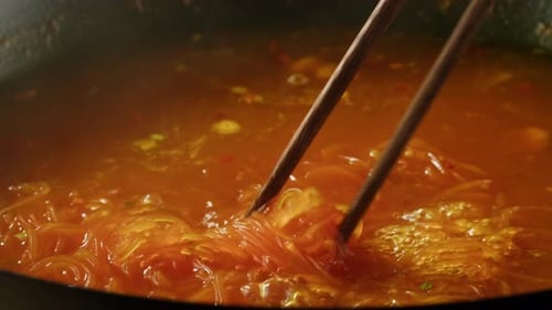 Close Up of Noodles Being Stirred in Broth