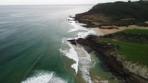 Cantabrian sea cliff shoreline Spain aerial of waves crashing on rocks