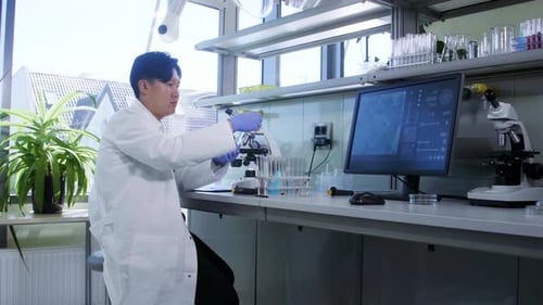 Scientist Working with Microscope in Modern Laboratory