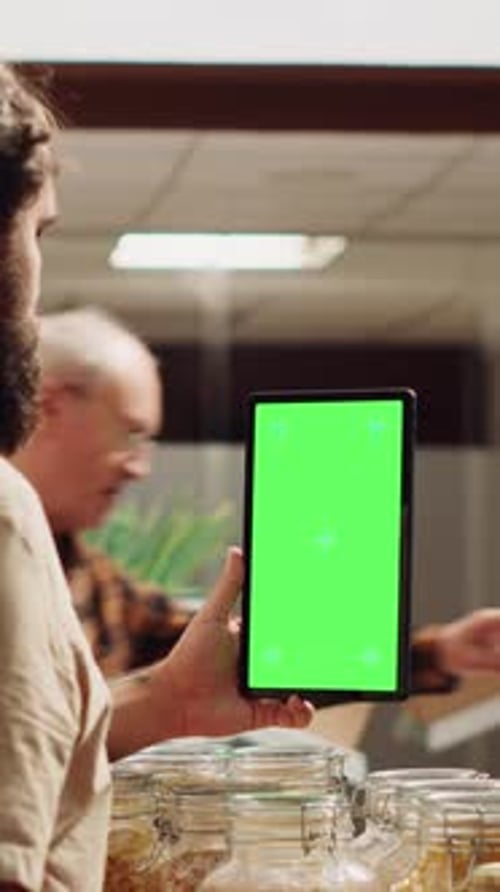Vertical Video Man Uses Chroma Key Phone in Bio Store
