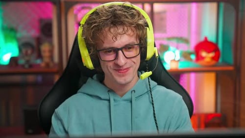 Smiling Young Adult Male with Headphones and Glasses
