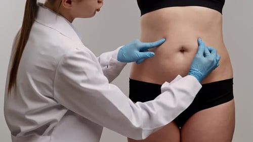 Healthcare Professional Examining Patient's Abdominal Area