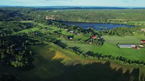 Snow-capped peaks and cascading waterfalls in Norway's aerial view.