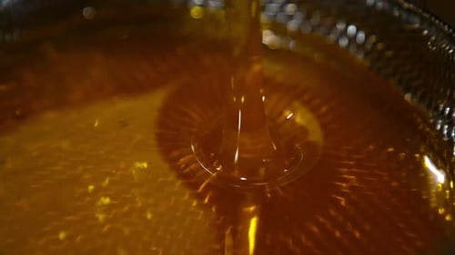 Healthy organic food dripping in macro shot. Sweet golden honey pouring.