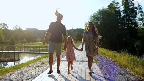 Happy Caucasian Family Walking Together with Cute Little Girl Mom Dad and Daughter Walk in Nature