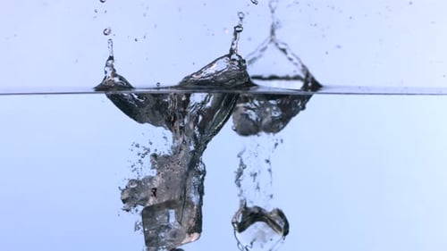 Ice Cubes Dropping Into Refreshing Water Tank