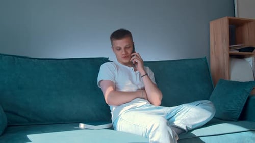 Young Adult Talking on the Phone at Home