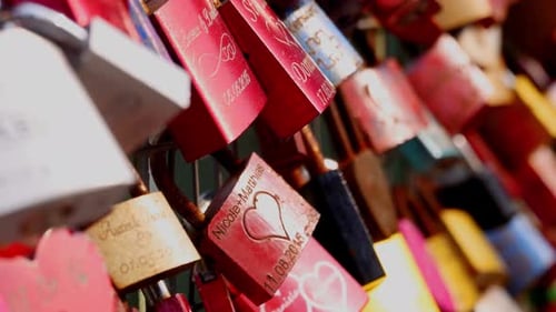 Many love locks in different colours with names and anniversary dates attached to bridge in Hamburg