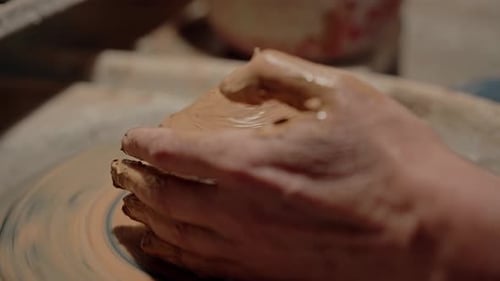 Hands Shaping Clay on Pottery Wheel